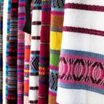 Vibrant woven fabrics showcasing traditional patterns in Antigua Guatemala market.